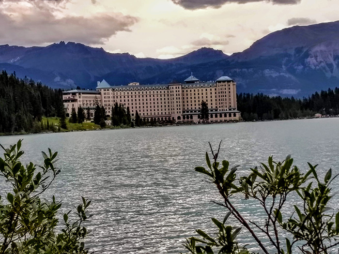 Canada Lake Louise Fairmon Chateau Hotel with Mountains in background - DJ Peace Pic - Awesome Entertainment Travel Blog